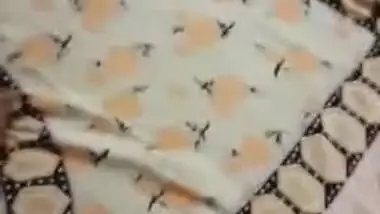 Desi woman lies in bed with legs spread while man touches XXX parts