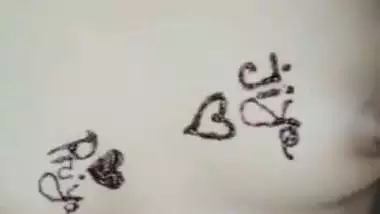 Nude girl puts henna on her naked body during a video call sex