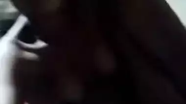 Naked Desi with dark skin does XXX porn on her own in the dark room