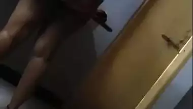 Hot figure standing topless in front of mirror